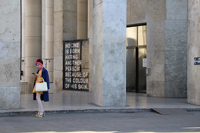 person in fashionable dress looking at phone