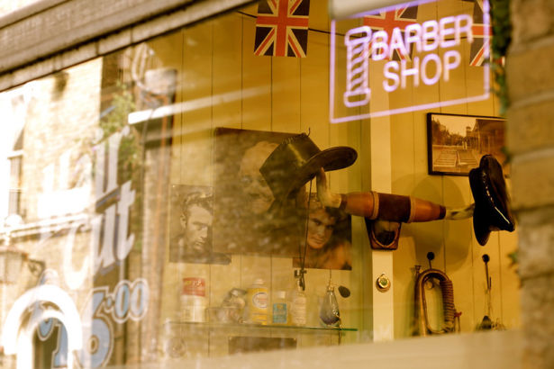 glass window with neon Barber Shop sign