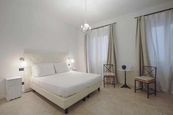 white hotel room with chandelier