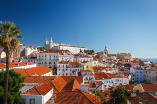 aerial view of white homes with orange roofs in Lisbon