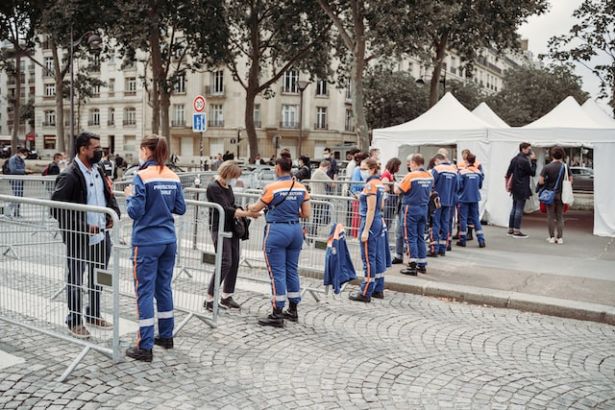 people at a testing site testing for covid while traveling in Paris, France