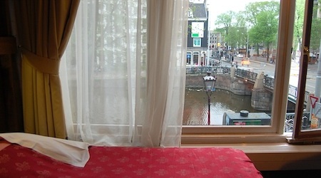 red bed by window overlooking canal