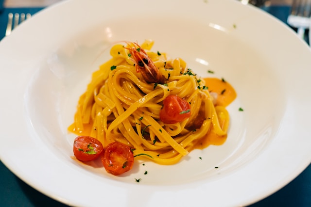 plate of pasta with shrimp and tomatoes