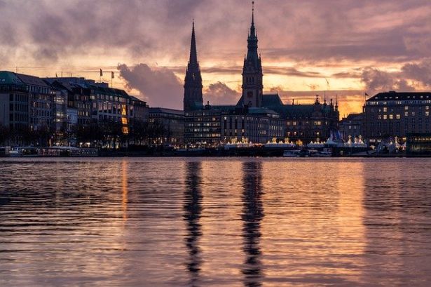 sun setting over Hamburg skyline