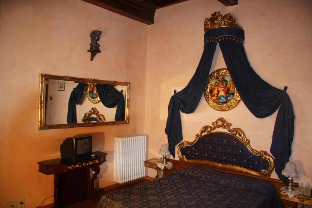 ornate bed and art in hotel room