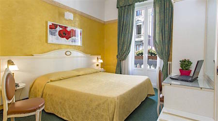 yellow and green hotel room at Hotel Charly, one of the best budget hotels in Milan