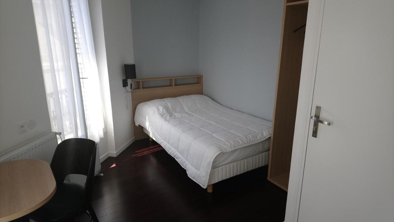 single bed in small hotel room