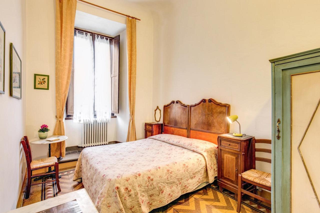 hotel room with antique furniture and large window