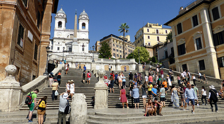people walking up the Spanish Steps to look for budget dining in Rome options